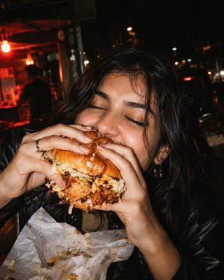 A bite of a Hot Mess burger