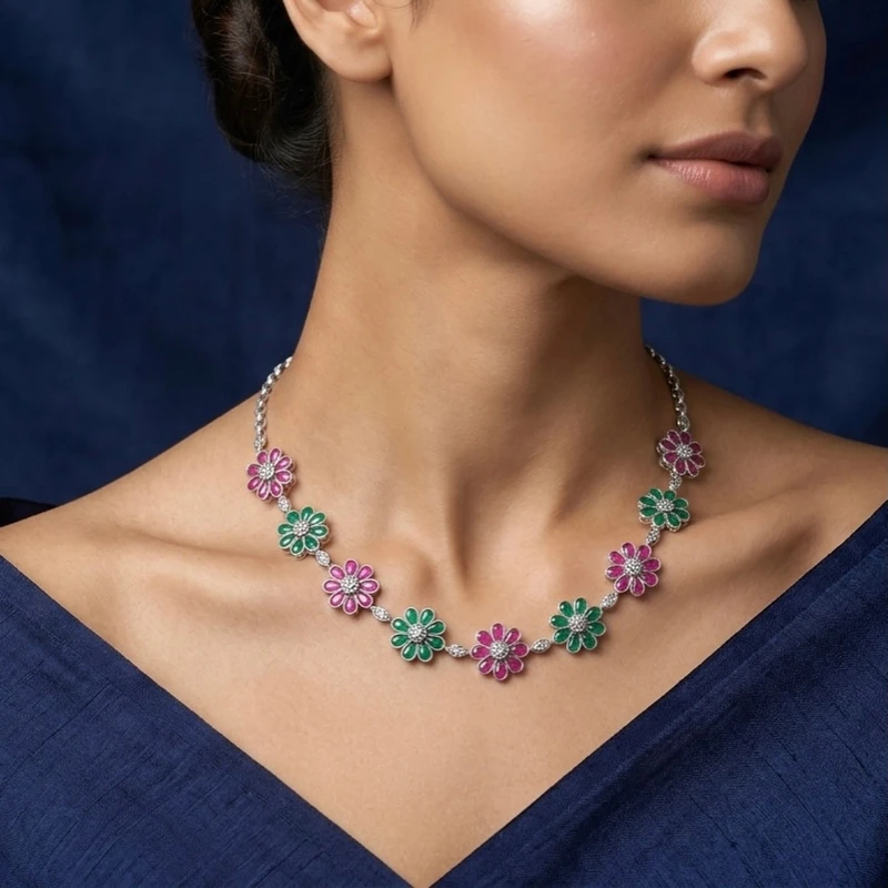 Portrait of a model wearing the complete floral necklace against a deep navy background.