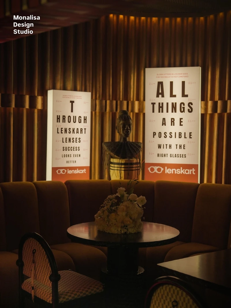 Photograph of two illuminated eye-chart panels installed in a dim lounge setting.