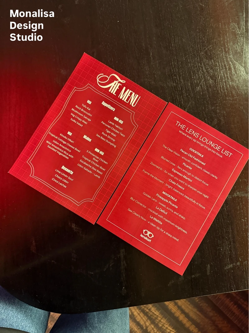 Photograph of an open red dinner menu on a dark tabletop.