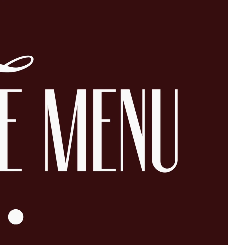 Cropped burgundy menu cover detail with tall condensed ivory lettering.